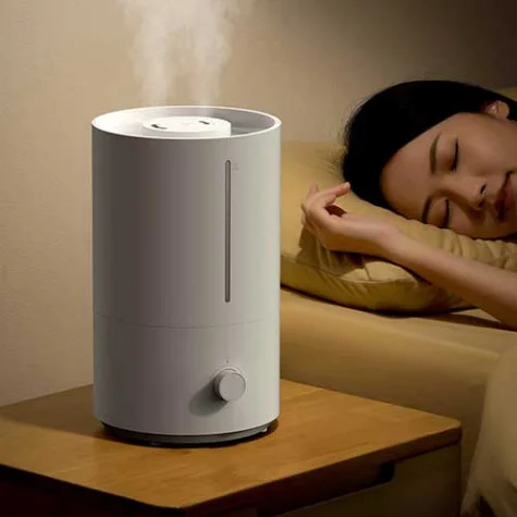 A cool mist humidifier running in a modern living room during summer.